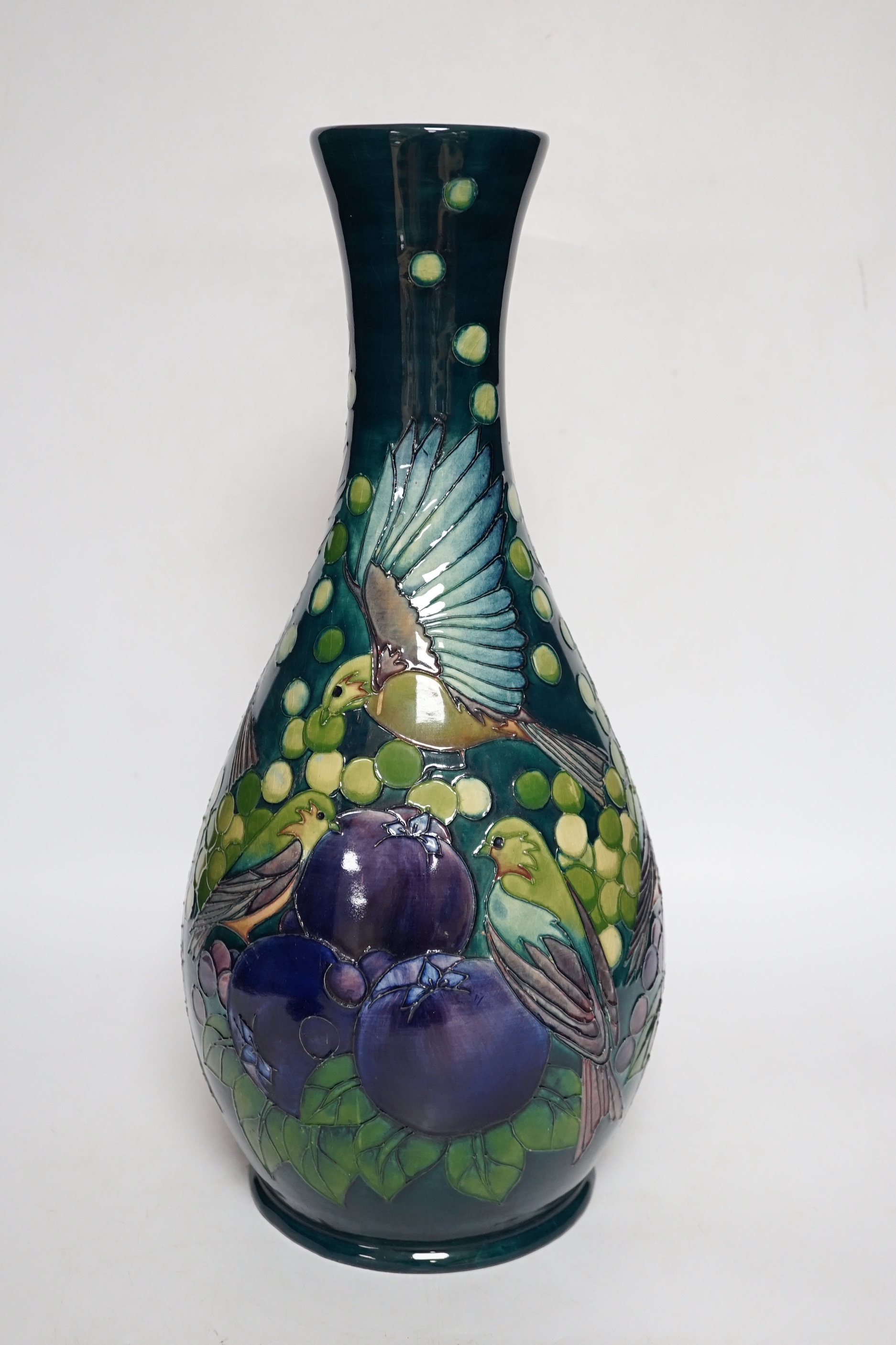 A large boxed Moorcroft vase, ‘Finches pattern’, on a dark blue-green ground, bell date mark to base, signed LS and dated 27.8.92, 42cm high